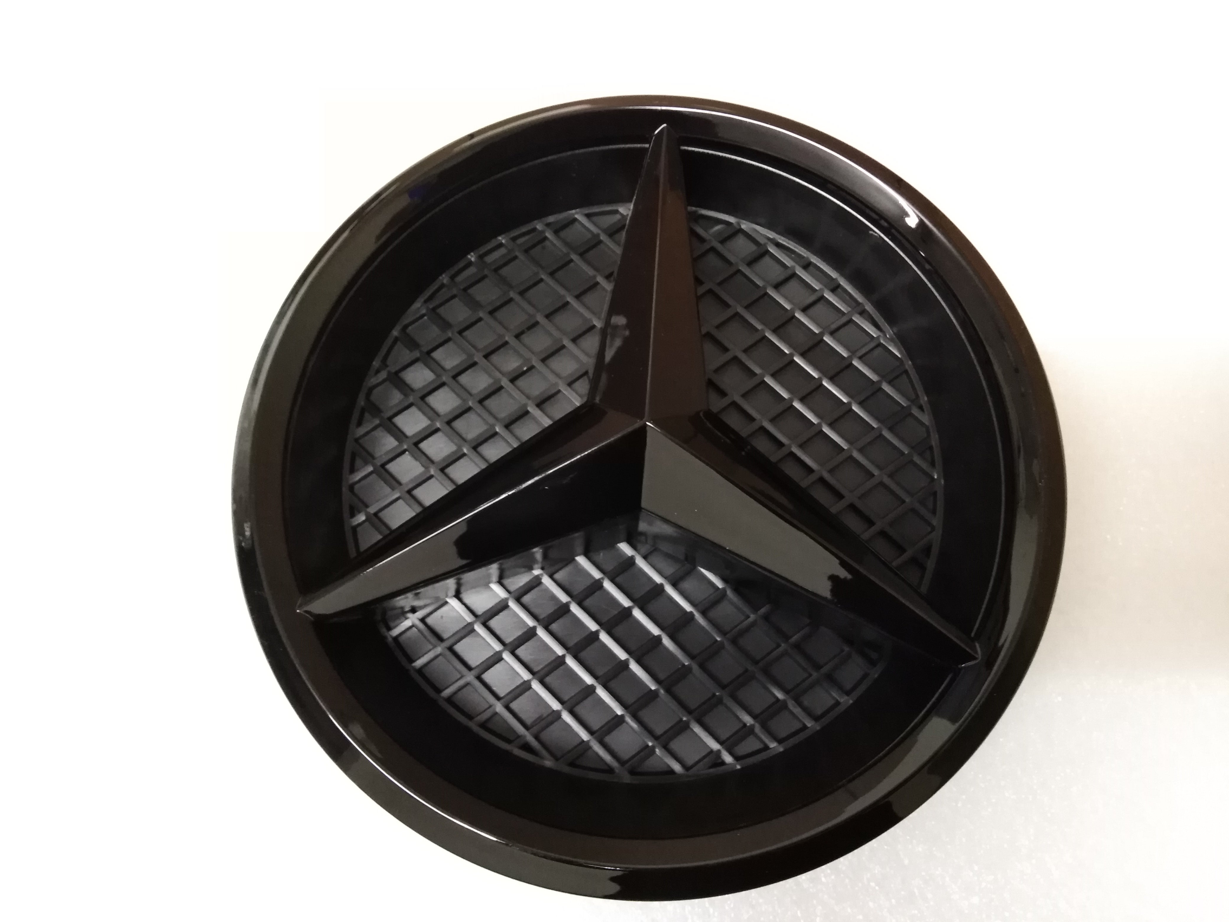 Black Mercedes emblem on white surface, suitable for 2016 onwards Benz E-Class W213 front grille.