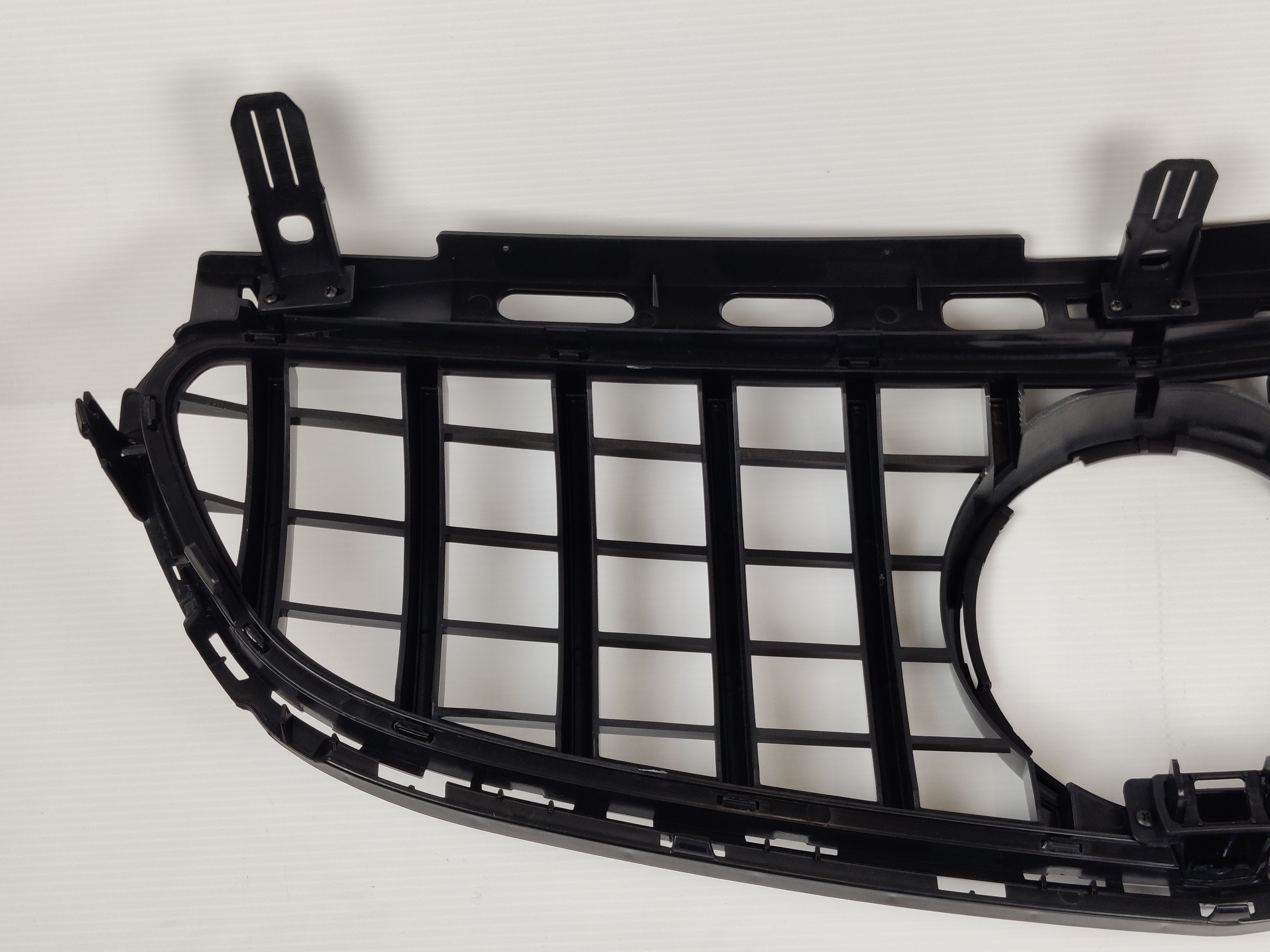 Black plastic grille for E500 E550 Front Bumper on a car.