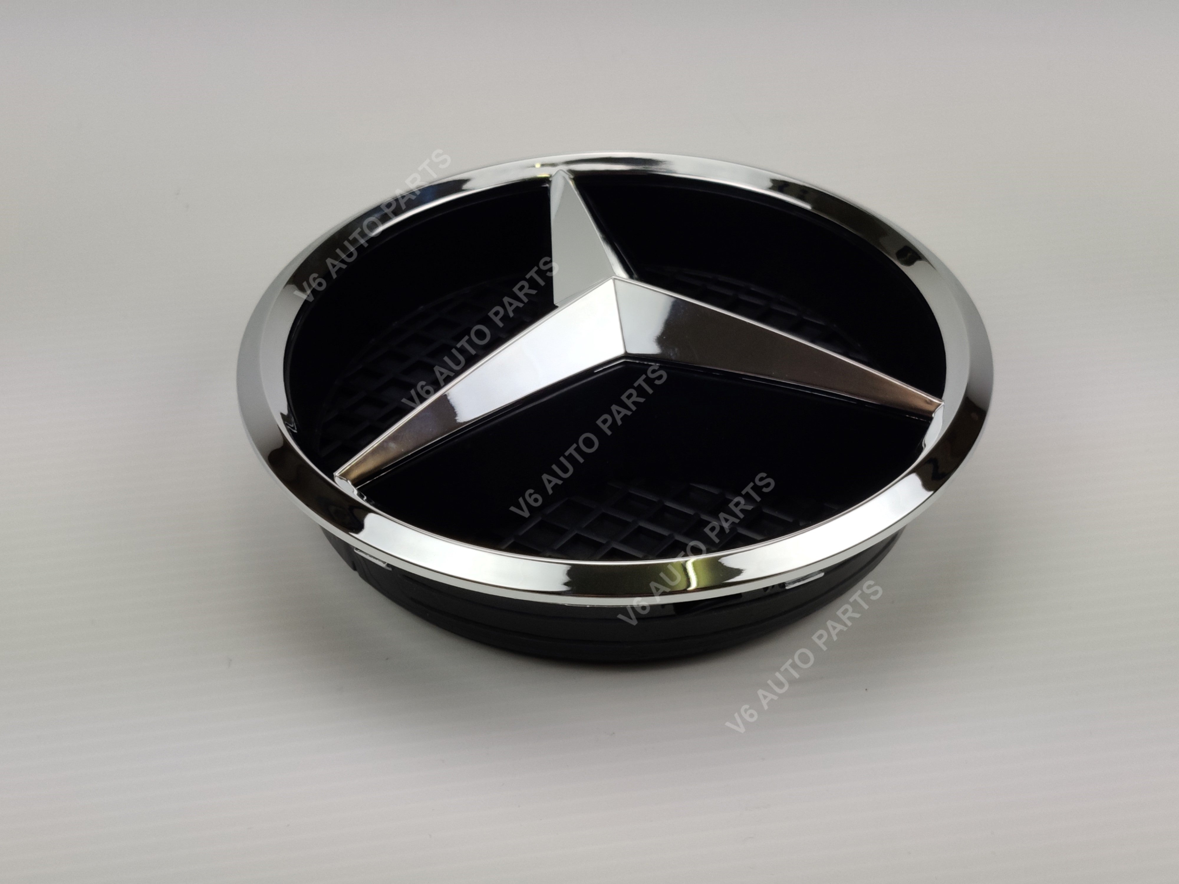 Chrome star badge base with Mercedes emblem on white background, E1-C front grille emblem for GLA-Class X156 2013-2018.